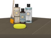 Retique It® Black Walnut kit with brush, Wood’n Primer, matte top coat, and yellow sponge on a wood surface.