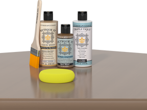 Barn Wood Kit with Light Wood Wood'n Primer, Barn Wood Gel Stain Alternative, Gloss Tripletique topcoat, a paintbrush, and a yellow sponge on a tabletop.
