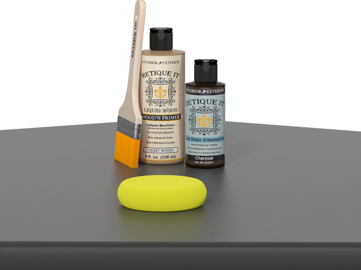 Retique It® Charcoal Kit with Light Wood’n Primer, Charcoal Gel Stain Alternative, paintbrush, and yellow sponge on a charcoal gray tabletop.