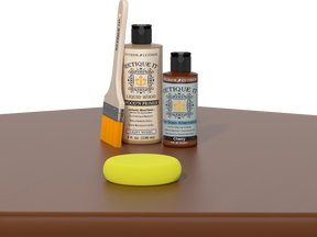 Retique It® Cherry Kit with Light Wood’n Primer, Cherry Gel Stain Alternative, paintbrush, and yellow sponge on a cherry wood tabletop.