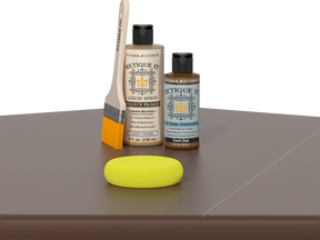 Retique It® Light Wood Wood’n Primer with Dark Oak Gel Stain Alternative, brush, and yellow sponge on a tabletop.