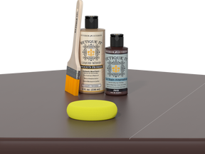 Retique It® Light Wood Wood’n Primer with Java Gel Stain Alternative, brush, and yellow sponge on a tabletop.
