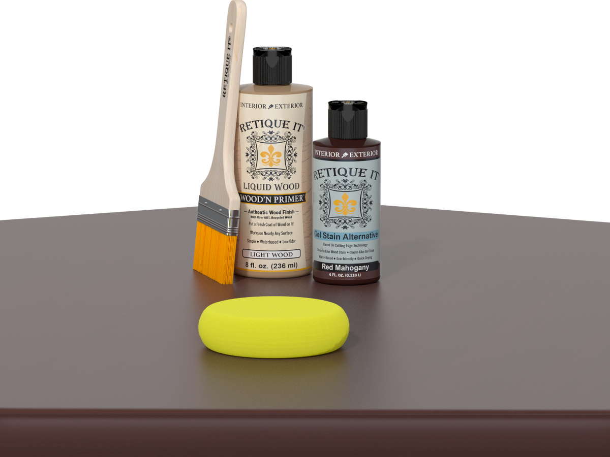 Retique It® Red Mahogany Kit with Light Wood’n Primer, Red Mahogany Gel Stain Alternative, paintbrush, and yellow sponge on a red mahogany tabletop.