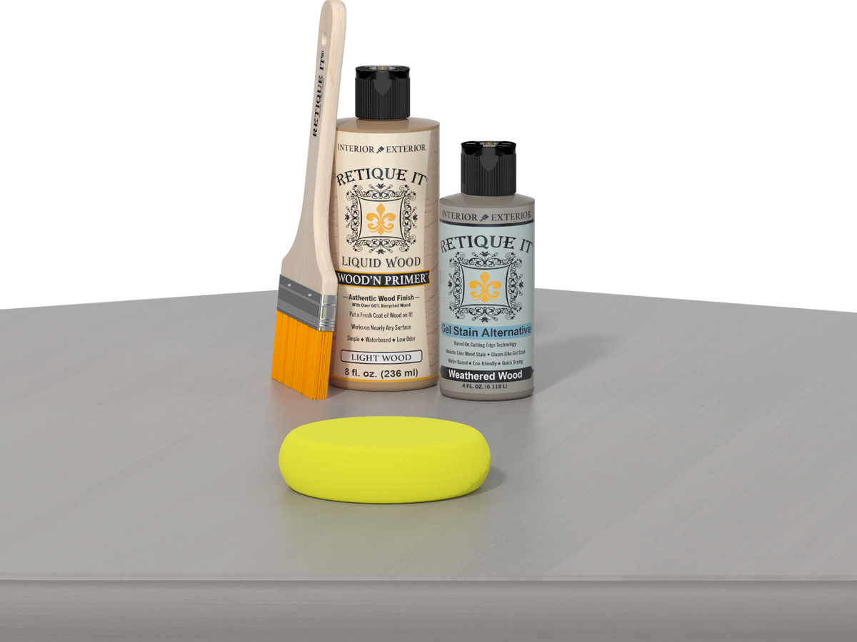 Retique It® Weathered Wood Kit with Light Wood’n Primer, Weathered Wood Gel Stain Alternative, paintbrush, and yellow sponge on a weathered wood tabletop.