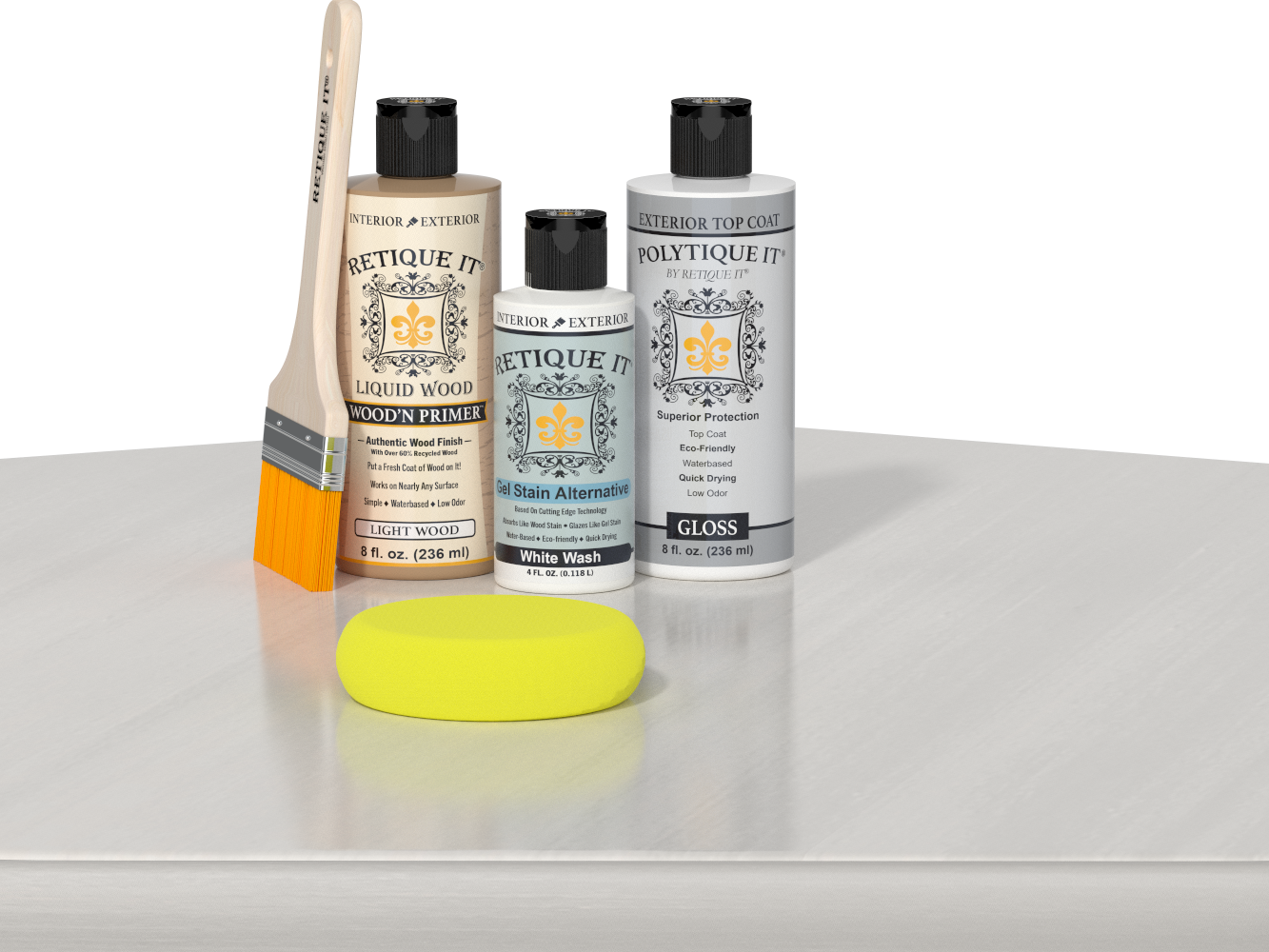 Retique It® Light Wood Wood’n Primer with White Wash Gel Stain Alternative, gloss topcoat, brush, and yellow sponge on a white tabletop.