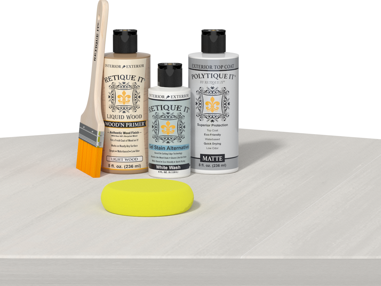 Retique It® Light Wood Wood’n Primer with White Wash Gel Stain Alternative, matte topcoat, brush, and yellow sponge on a white tabletop.