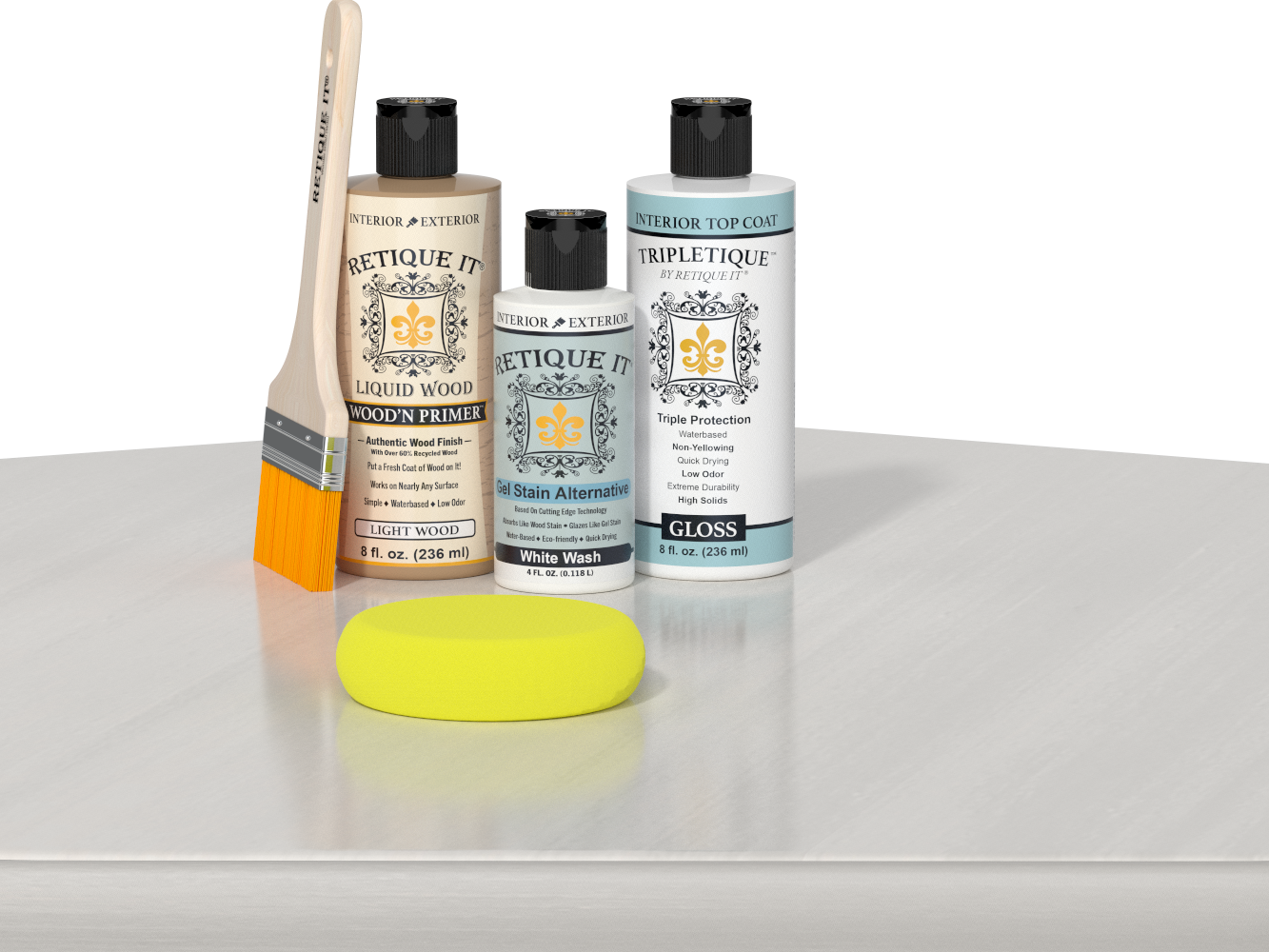 Retique It® Light Wood Wood’n Primer with White Wash Gel Stain Alternative, gloss topcoat, brush, and yellow sponge on a white tabletop.