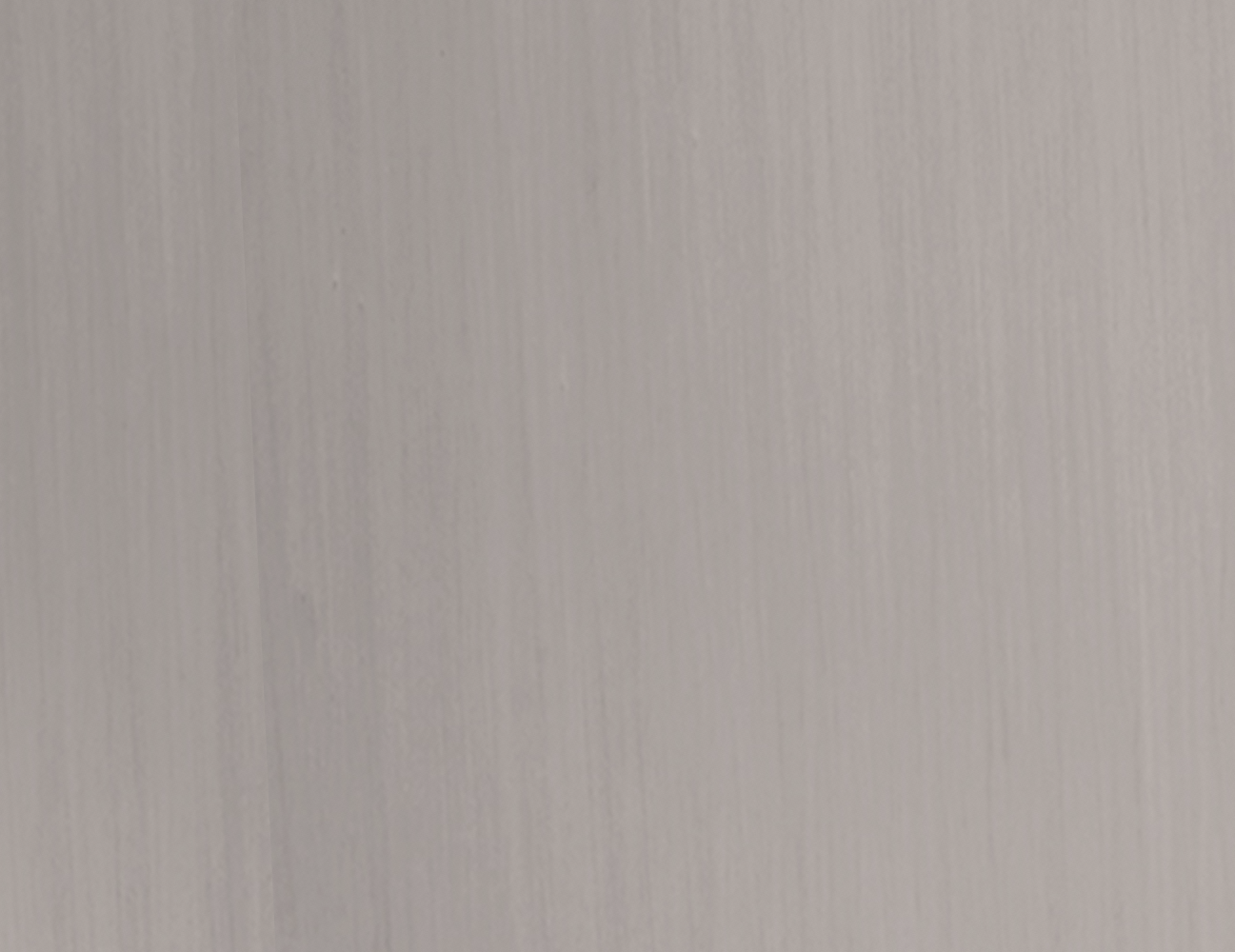 Pale gray-white finish swatch with subtle vertical wood-grain texture.
