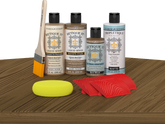 Retique It® Wood'n Finish Kit in Barn Wood stain displayed on a table, showcasing natural wood finish for furniture refinishing.