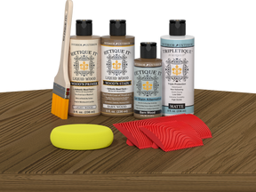 Retique It® Wood'n Finish Kit in Barn Wood stain displayed on a table, showcasing natural wood finish for furniture refinishing.
