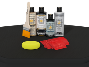 Set of automotive care products including bottles, a brush, and cloths on a black surface.