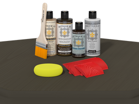Set of wood care products including bottles, a brush, a sponge, and cloths on a dark surface.
