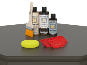 Set of wood care products including bottles, a brush, and cloths on a gray surface.