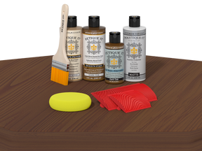 Wood care products including bottles, a brush, a sponge, and cloths on a wooden surface.