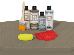 Set of wood care products including bottles, a brush, and cloths on a gray surface.