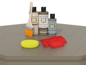 Set of wood care products including bottles, a brush, and sponges on a gray surface.