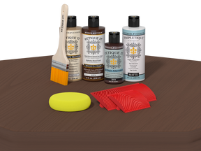 Set of wood care products including bottles, a brush, a sponge, and cloths on a brown surface.