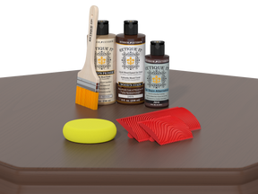 Retique It wood care products including bottles, a brush, a yellow sponge, and red applicators on a gray surface.