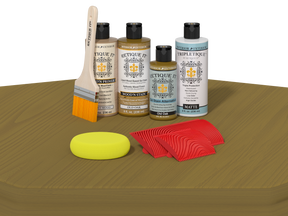 Set of wood care products including bottles, a brush, and cloths on a wooden surface.