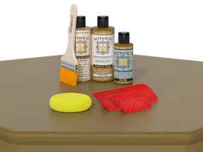 Set of wood staining products including bottles, a brush, and samples on a wooden surface.