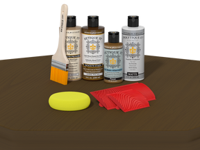 Set of wood care products including bottles, a brush, and cloths on a brown surface.