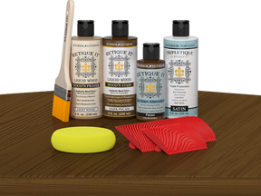 Retique It® Dark Pecan Wood'n Kit with Light Wood primer, Dark Pecan stain, Pecan gel stain alternative, Satin Tripletique® Top Coat, brush, red graining tool, and yellow sponge.