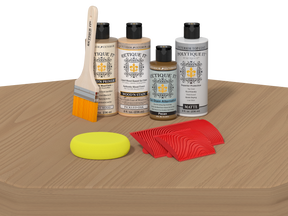 Set of wood care products including bottles, a brush, and cloths on a wooden surface.