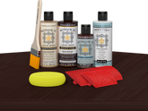 Retique It® Red Mahogany Wood'n Kit with Light Wood primer, Red Mahogany stain, Red Mahogany gel stain alternative, Matte Tripletique® Top Coat, brush, red graining tool, and yellow sponge.