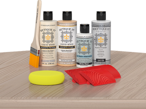Retique It® Wood'n Finish Kit in Sun Bleached for exterior wood surfaces, with a palette of top coat options on a table.