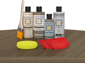 Retique It® Wood'n Finish Kit in Weathered Wood, featuring exterior top coat and wood finish supplies on a table.