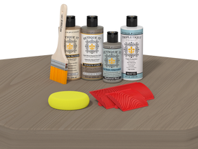 Set of wood staining products including bottles, a brush, and applicators on a wooden surface.