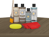 Retique It® Weathered Wood Wood'n Kit with Light Wood primer, Weathered Wood stain, Weathered Wood gel stain alternative, Matte Tripletique® Top Coat, brush, red graining tool, and yellow sponge.