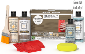 Retique It® Weathered Wood Wood'n Kit with Matte TripleTique® shown with the Weathered Wood Multipurpose Kit box, brush, Light Wood primer, Weathered Wood stain, Weathered Wood Gel Stain Alternative, Matte TripleTique® top coat, a yellow sponge, and a red graining tool.