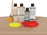 Retique It® White Oak Wood'n Kit with Bleached Wood Primer, Pickled Oak Wood'n Stain, Matte TripleTique Top Coat, Pecan Gel Stain Alternative, yellow sponge, red graining tool, and brush.