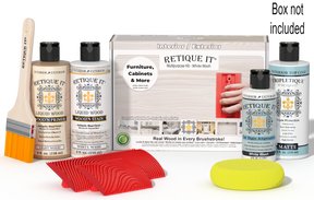 Retique It® White Wash Multipurpose Kit with Light Wood primer, White Wash stain, White Wash gel stain alternative, Matte Tripletique® Top Coat, brush, red graining tool, yellow sponge, and product box.