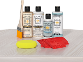 Retique It® White Wash Wood'n Kit with Light Wood primer, White Wash stain, White Wash gel stain alternative, Satin Tripletique® Top Coat, brush, red graining tool, and yellow sponge.