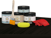 Retique It® countertop kit for kitchen island in classic black with wood stain finish, displayed on a kitchen table.