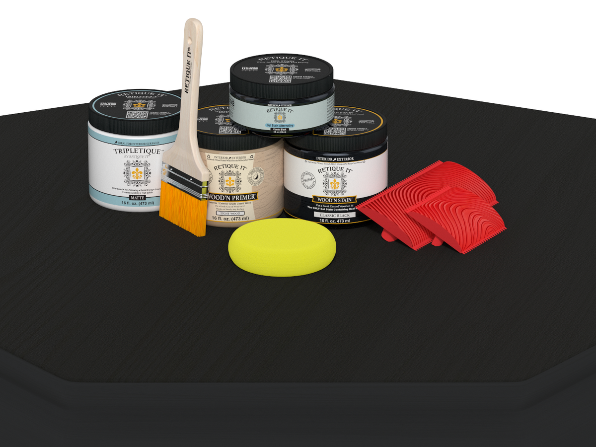 Collection of paint cans, a brush, a sponge, and red tools on a black surface.