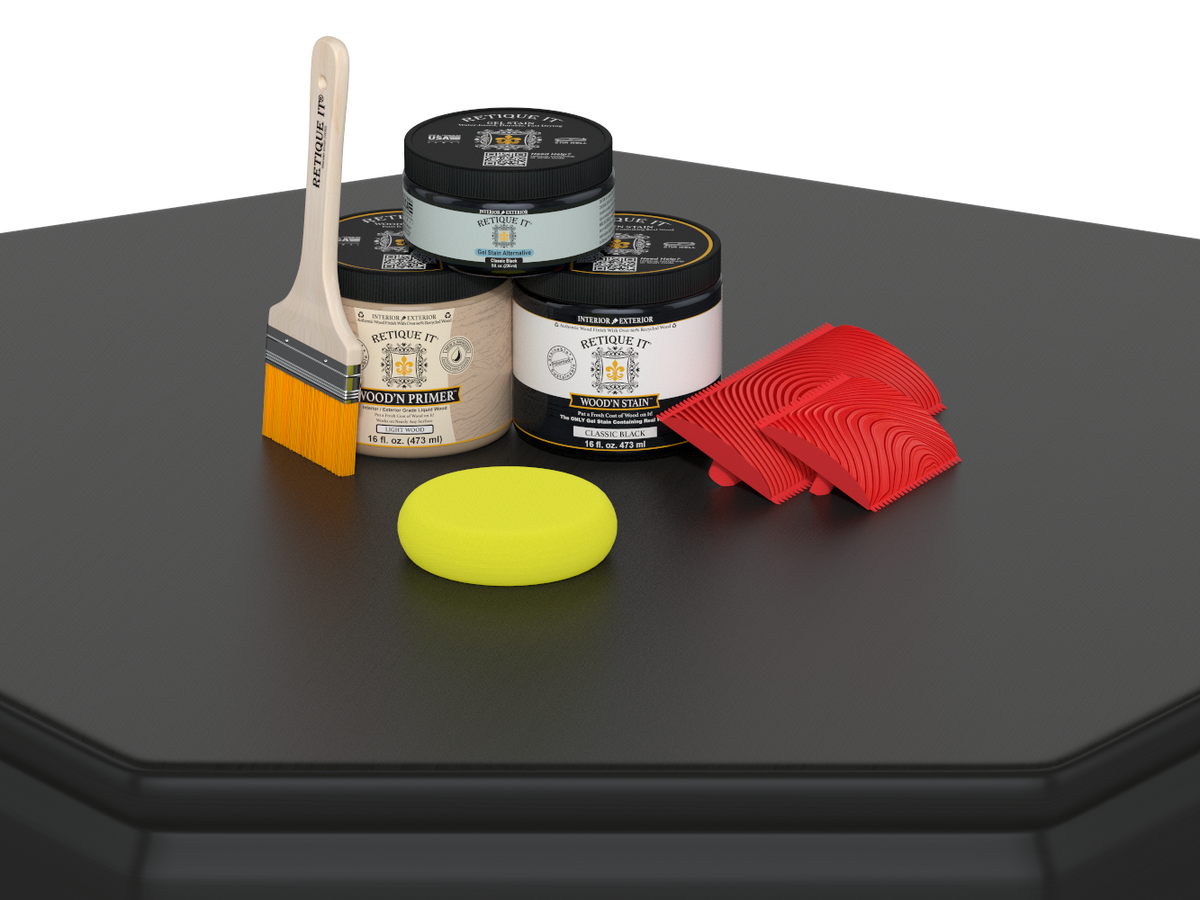 Painting supplies including jars, a brush, a sponge, and a roller on a black surface.