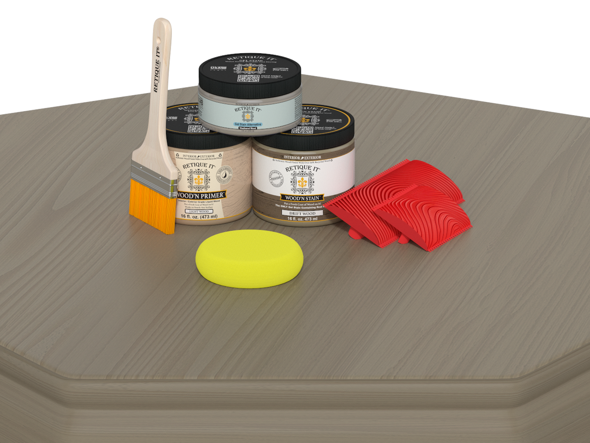 Painting supplies including jars, a brush, a sponge, and scrapers on a wooden surface.