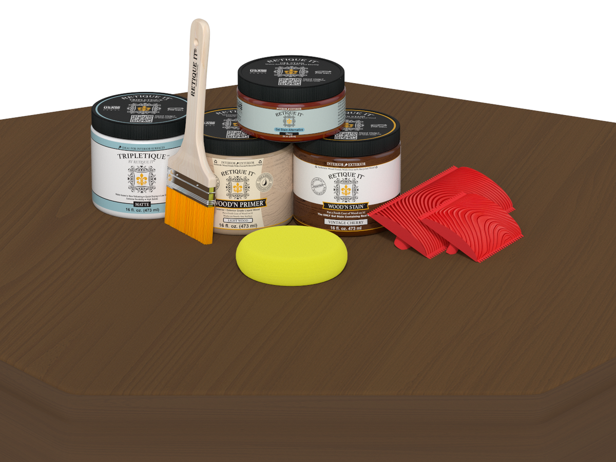 Collection of paint-related items including jars, a brush, and a sponge on a brown surface.