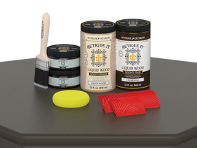 Retique It® liquid wood stain kit with a brush, sponge, and sponge and graining tools on a Charcoal surface.