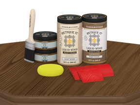 Retique It® Modern Walnut Wood Kit with primer, stain, brush, yellow sponge, and red graining tools on a wood tabletop.