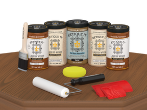 Retique It® Wood'n Cabinet Kit with 24 cedar-grained stain doors displayed on a table for kitchen cabinet renovation.