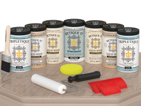 Retique It® Wood'n Cabinet Kit with 24 sun-bleached grained doors, glossy wood finish, displayed on a table.