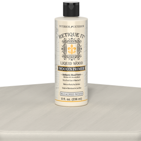 Retique It Liquid Wood Wood'n Primer in bleached wood finish, 8 fl oz, shown on a table surface for wood refinishing projects.