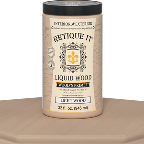 Retique It® Liquid Wood Wood'n Primer in light wood finish, 32 fl oz, shown on a table surface for wood crafting projects.