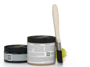 Two jars of a product with a brush on a white background