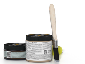 Two jars of a product with a brush on a white background