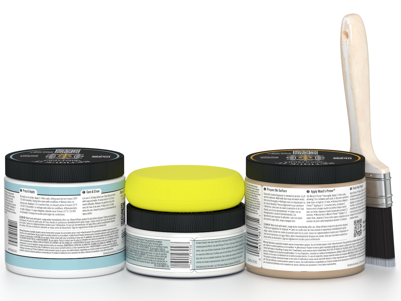 Three jars of paint with black lids and a paintbrush on a white background